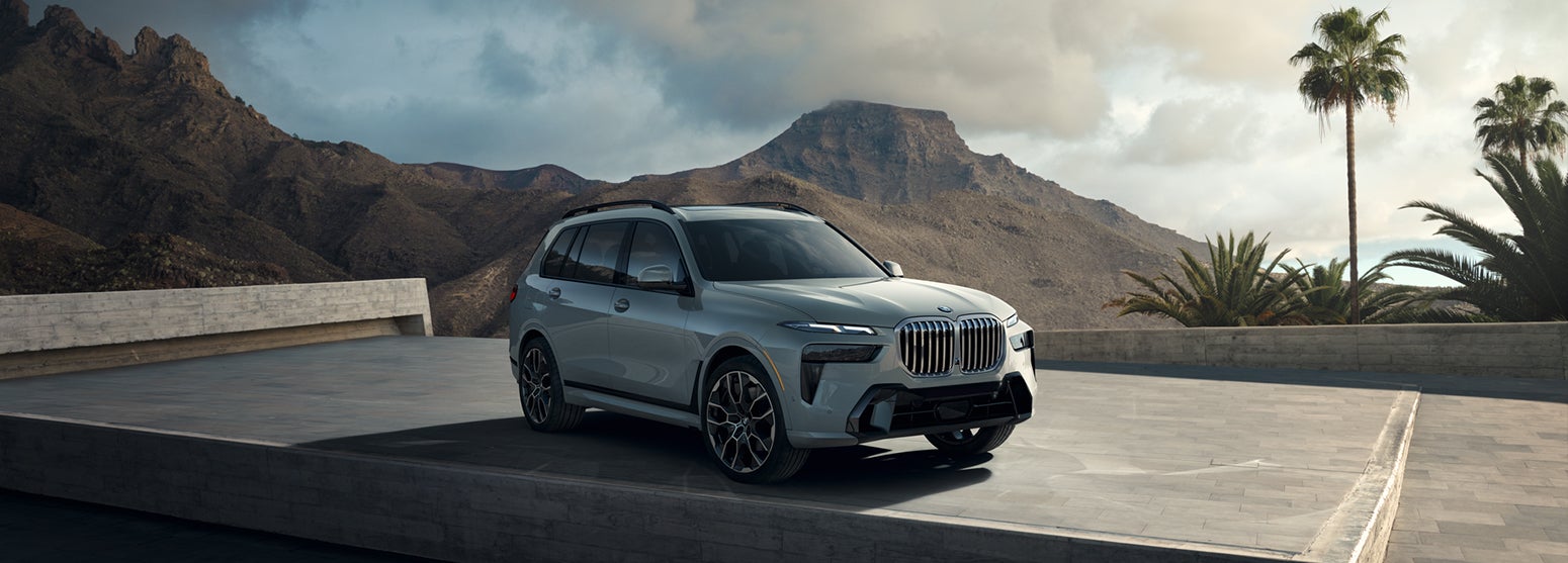 Gray BMW X7 parked with mountain and palm tree background | Passport BMW in Suitland MD