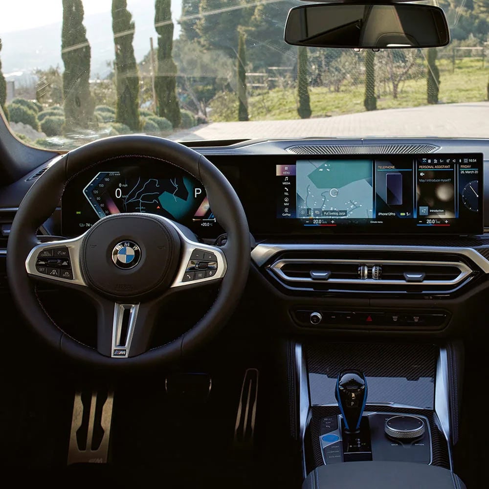 A driver's eye view of steering wheel and controls of the BMW i4 | Passport BMW in Suitland MD