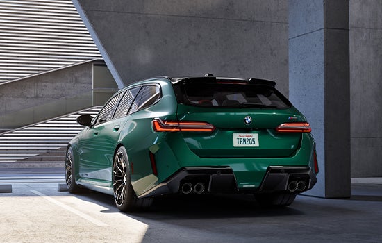 Green BMW M5 Touring parked in garage. | Passport BMW in Suitland MD