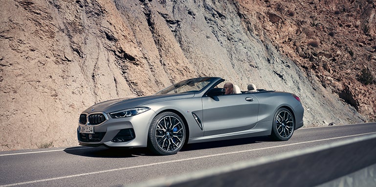 Grey BMW convertible driving around a mountain | Passport BMW in Suitland MD