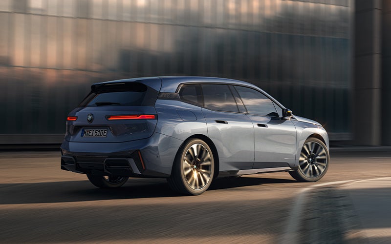 The BMW iX driving with the front wheel turned. | Passport BMW in Suitland MD