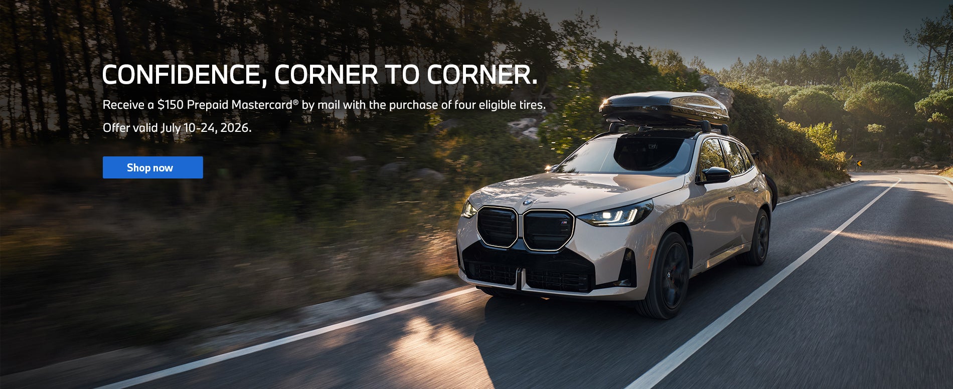 A front, three quarter view of white BMW X3 is driving on a 